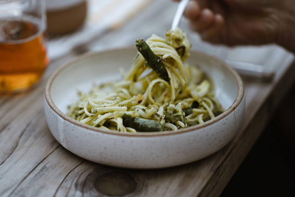 white bowl with speckled clay and pasta